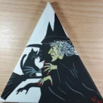 Witch with cat on a broomstick painting.