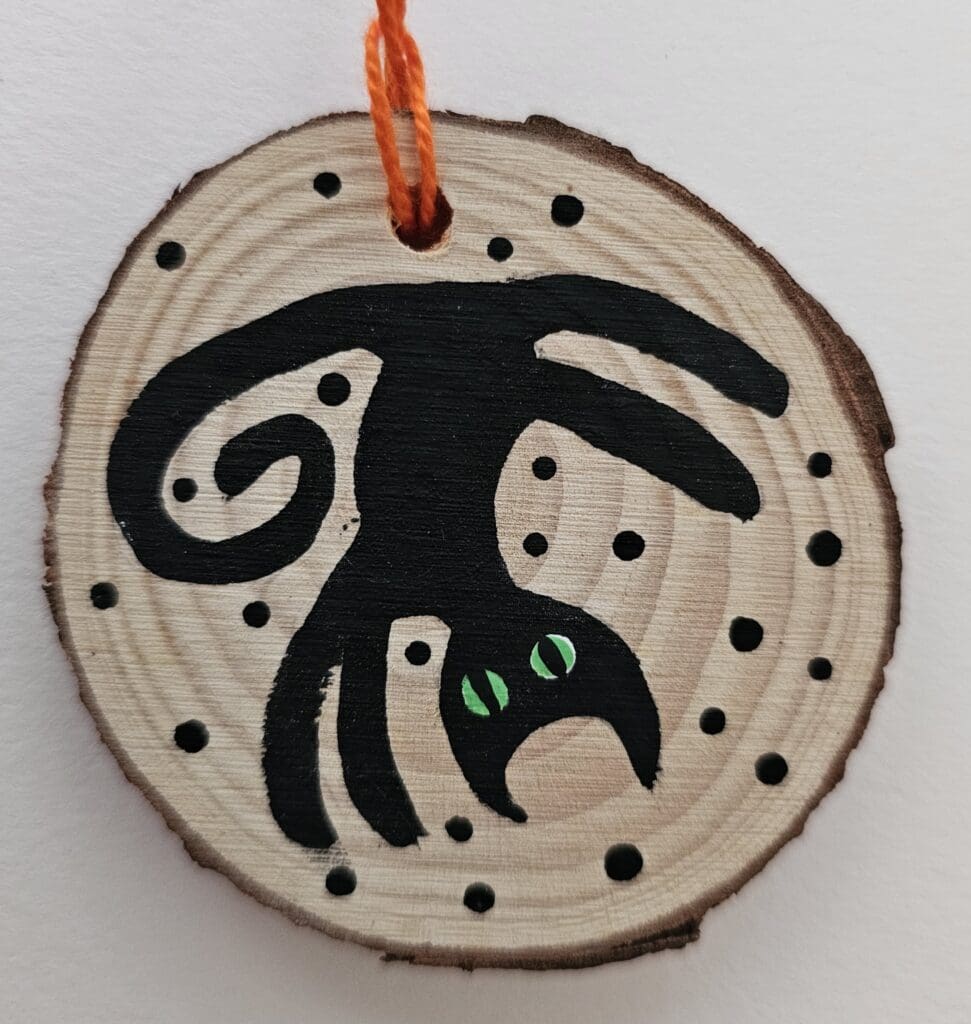 A wooden disc with an animal on it