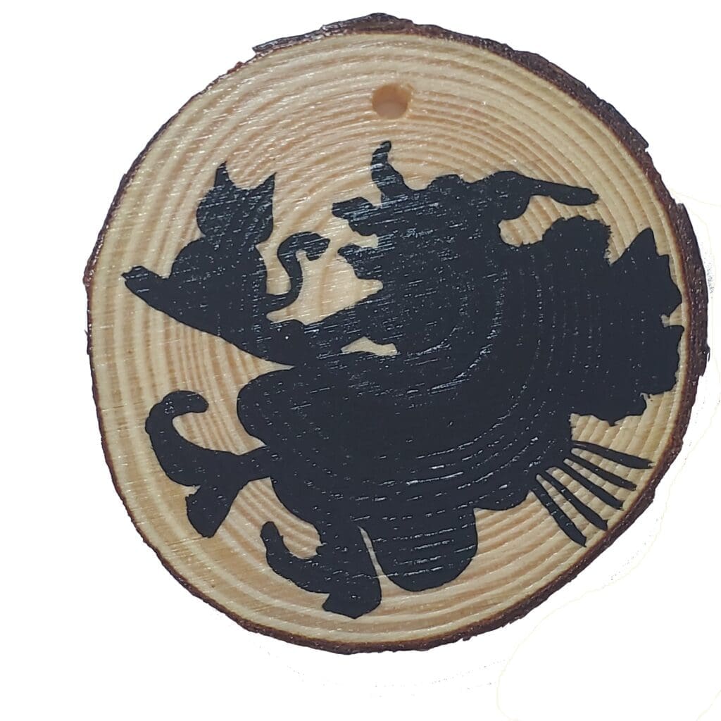 A wooden disc with an image of a dragon on it.