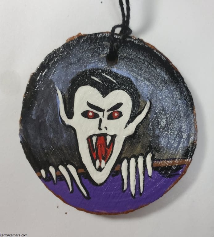 A painting of a vampire on a piece of wood.