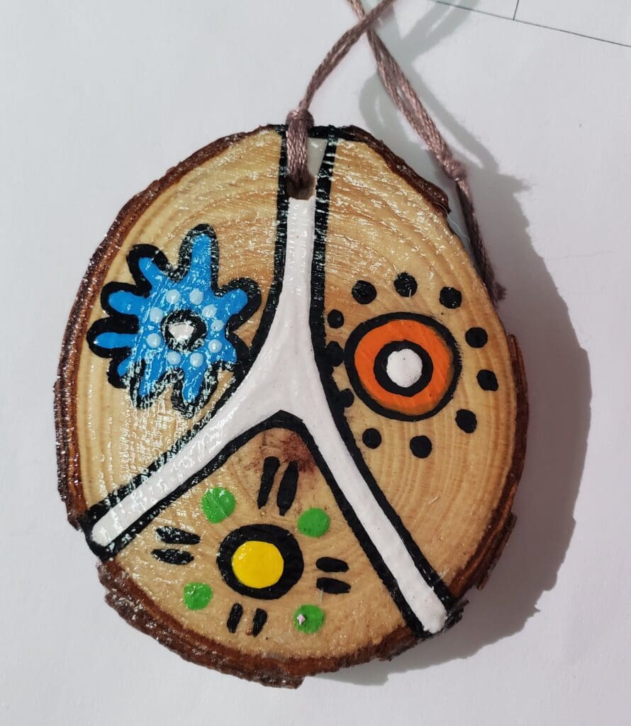 A wooden disc with some designs on it