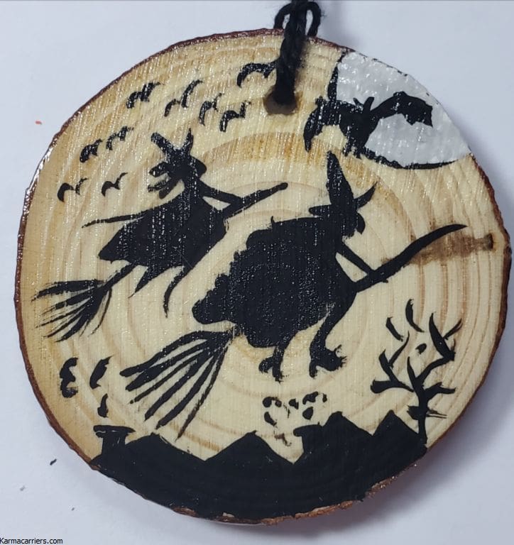 A wooden disc with witches on it