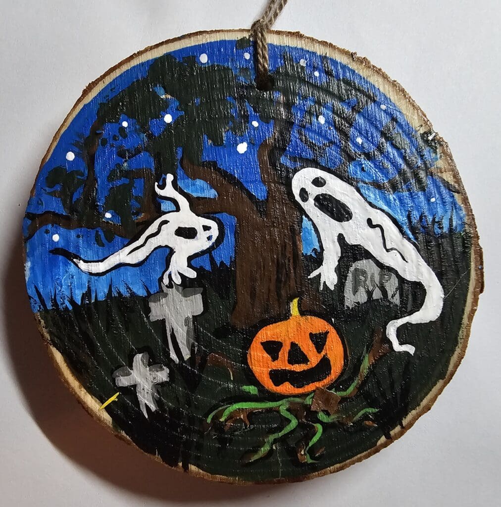 A painting of ghosts and pumpkins on a tree.