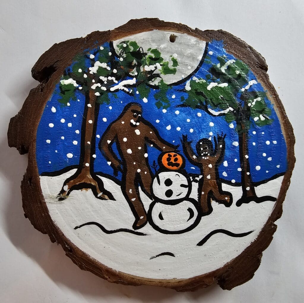 A cookie with a deer and snowman on it