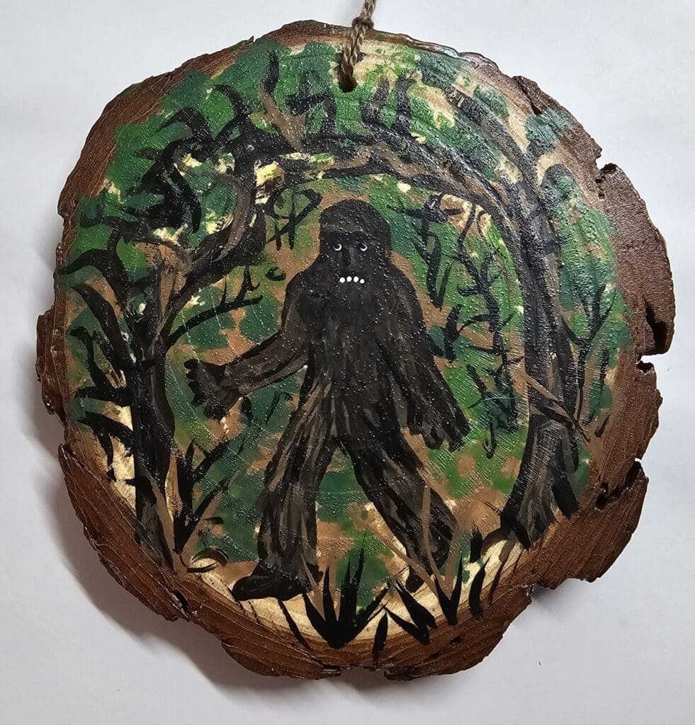 A painting of bigfoot on wood slice