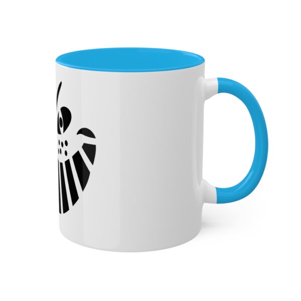 A white and blue coffee mug with the shield of loki on it.