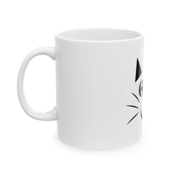 A white coffee mug with a cat on it.