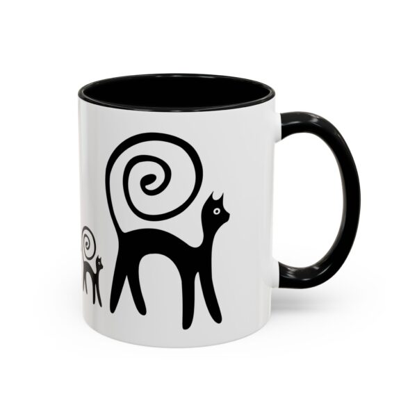 A black and white mug with a cat design