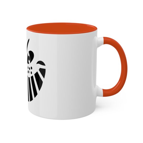 A white and orange coffee mug with an image of the symbol for the marvel comics.