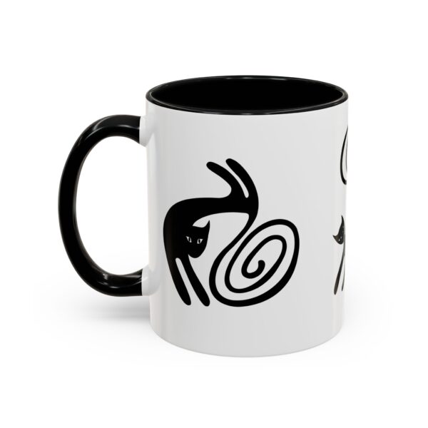 A black and white mug with some designs on it