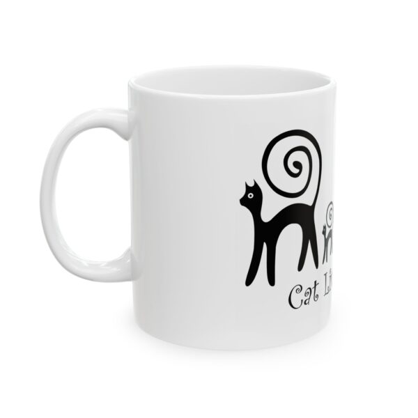 A white mug with a black cat on it