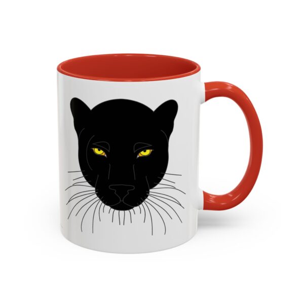 A red and white mug with an image of a black cat.