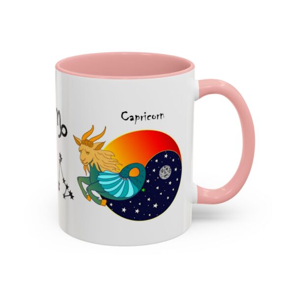 A pink and white coffee mug with an astrology design.