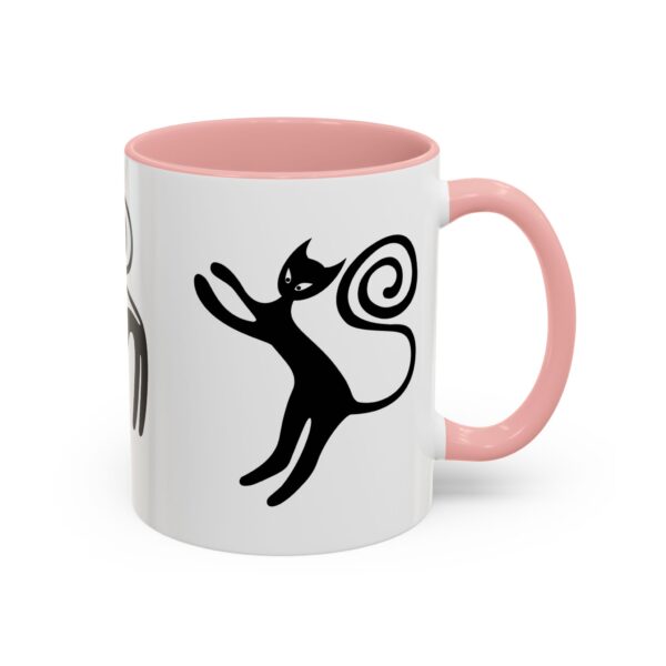 A pink and white mug with a cat design on it