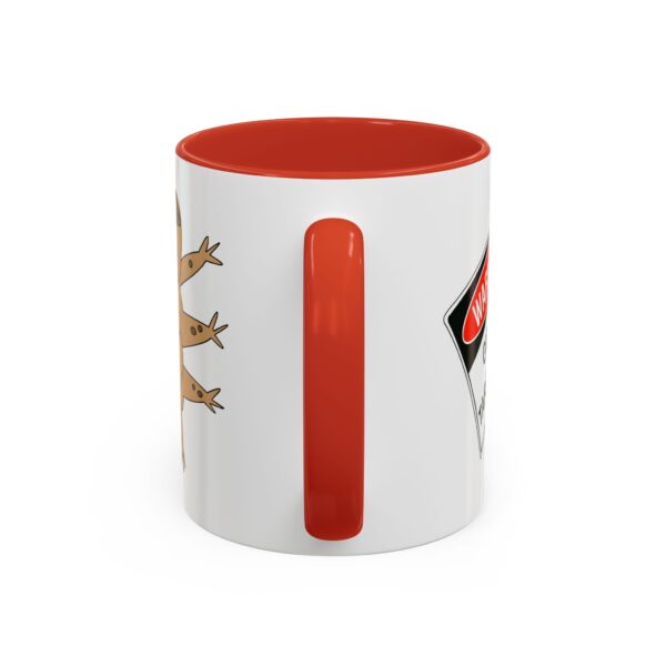 A red and white mug with some animals on it