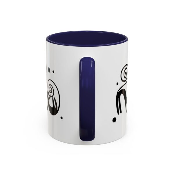 A white mug with black and blue design on it.