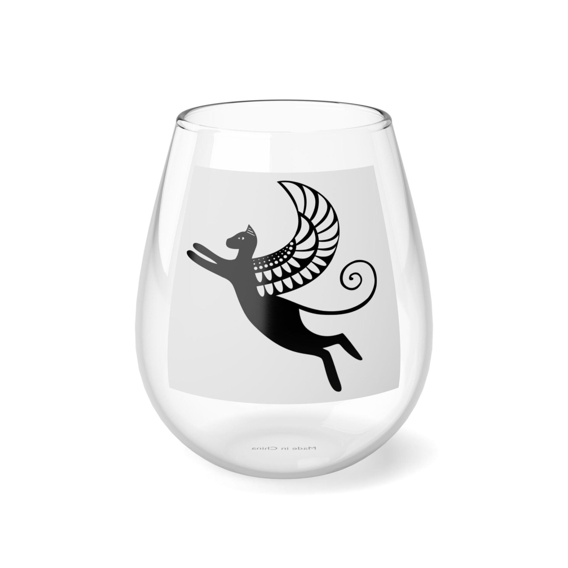 A glass with an image of a cat and a bird.