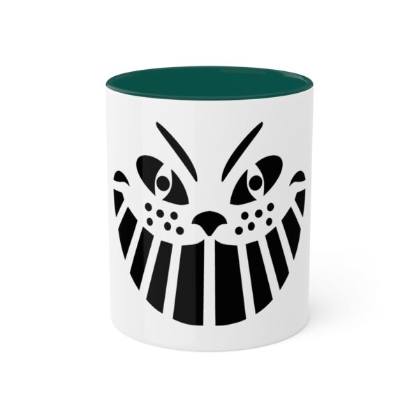 A green and white mug with an image of a cat 's face.