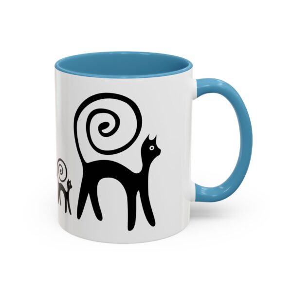 A blue and white mug with an image of two cats