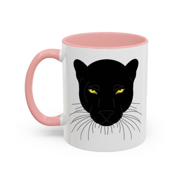 A pink and white mug with a black cat face on it