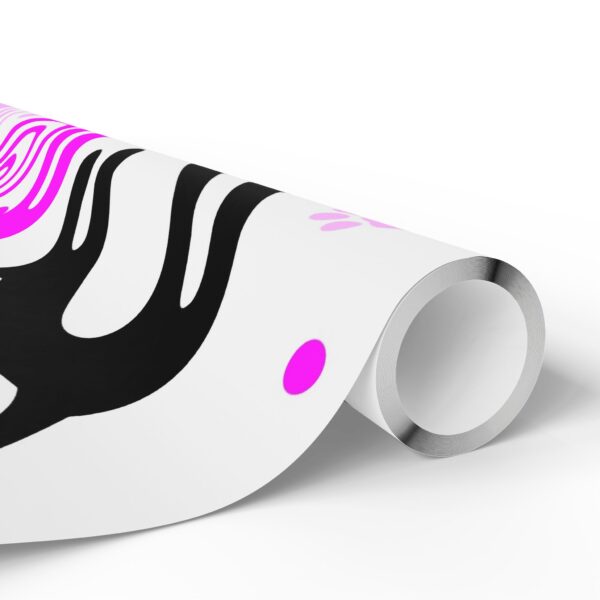 A roll of paper with pink and black designs on it.