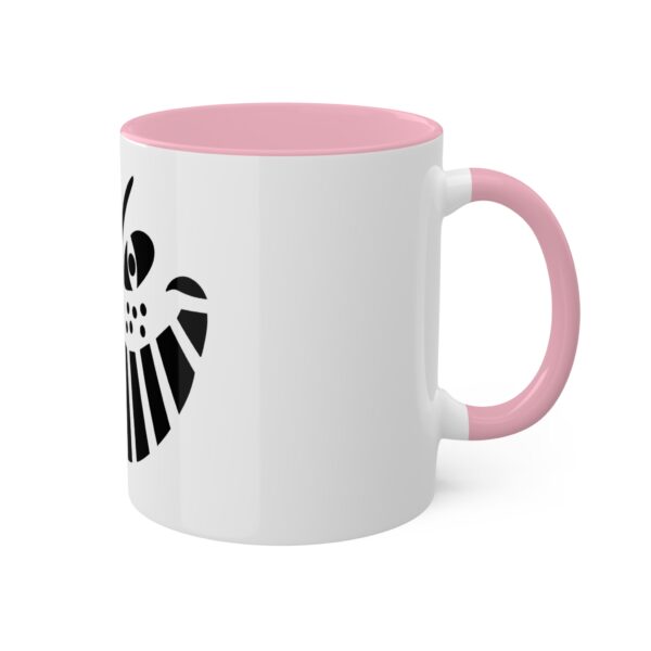 A pink and white coffee mug with the symbol of an owl.