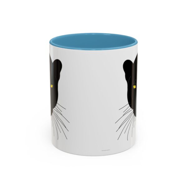 A white and blue mug with a black cat on it.