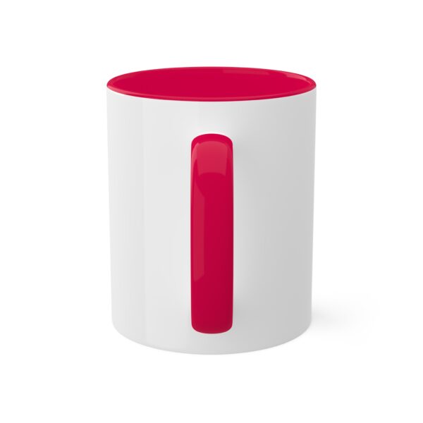 A white and red mug with the handle up.