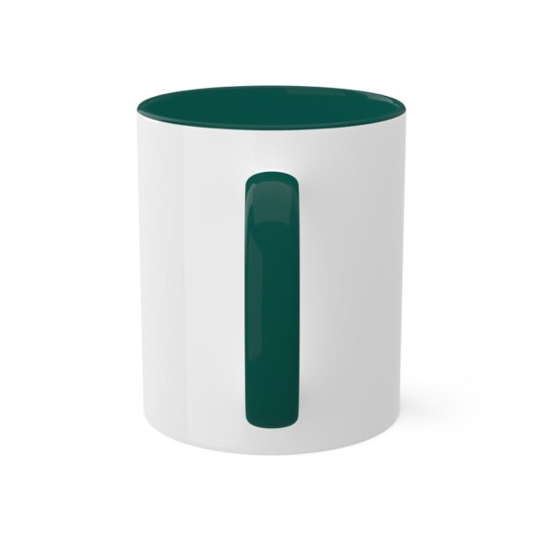 A white mug with a green handle and bottom.