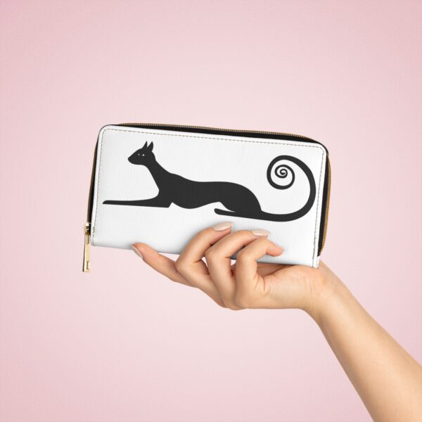 A person holding onto a wallet with a cat on it