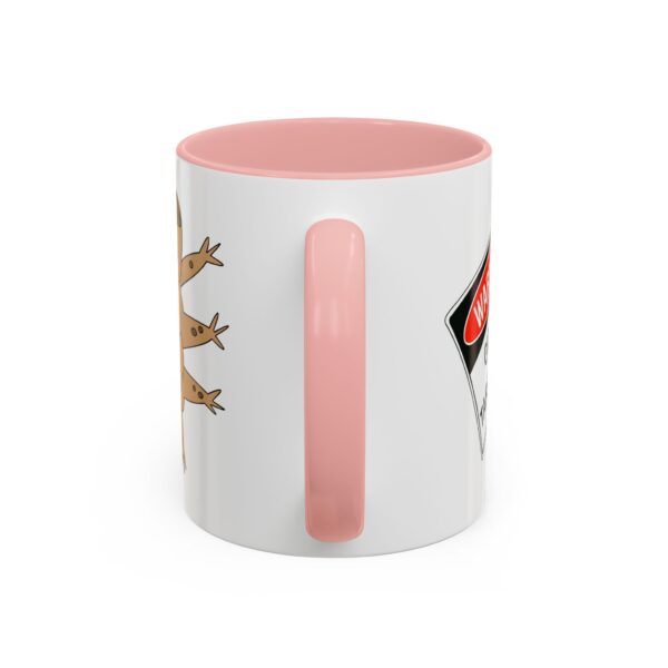 A pink and white mug with some animals on it