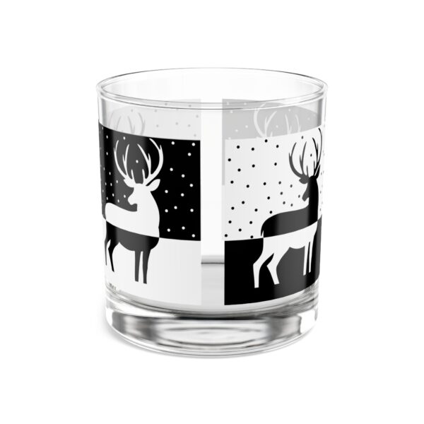 A glass with deer on it and black and white design.