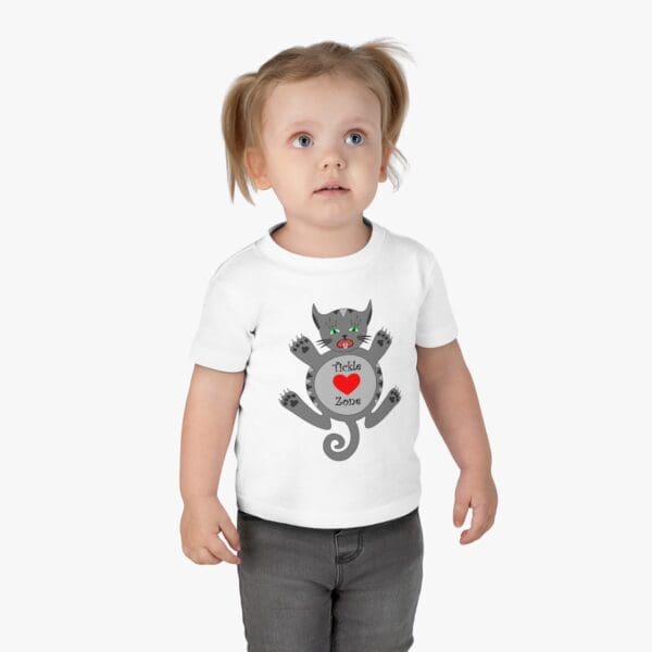 A toddler wearing a t-shirt with an image of a cat.