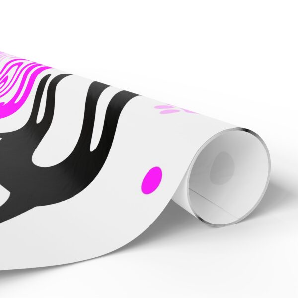 A roll of paper with pink and black designs on it.