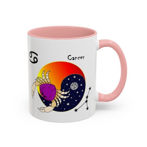 A pink and white coffee mug with the zodiac sign cancer on it.