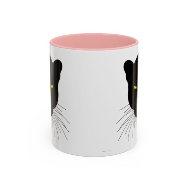 A pink and white coffee mug with a black cat on it.