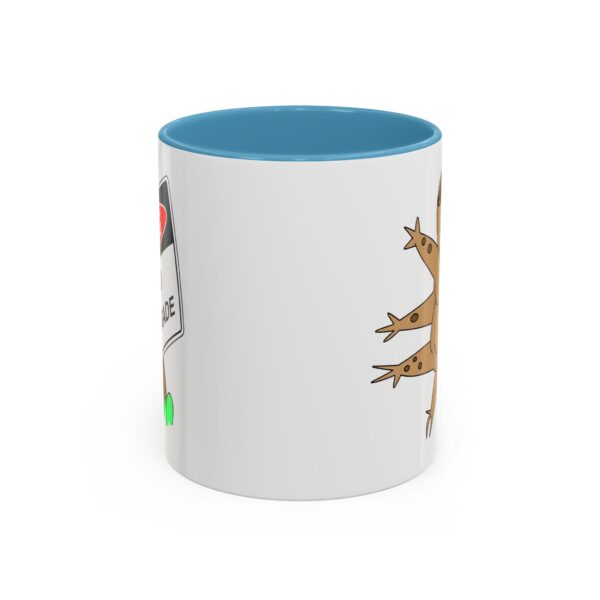 A blue and white mug with a picture of a lizard