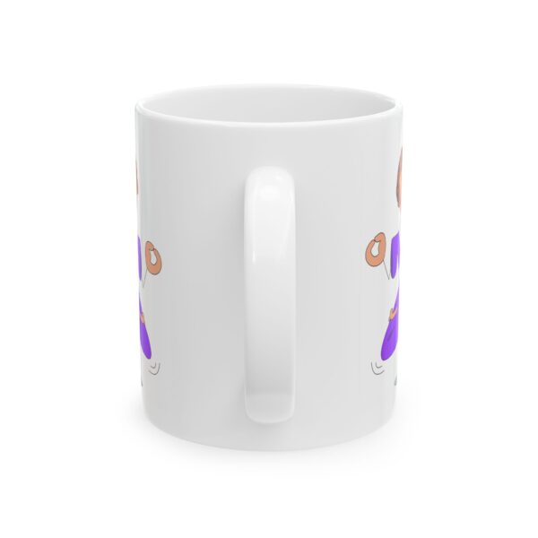 A white coffee mug with an image of a person holding something.