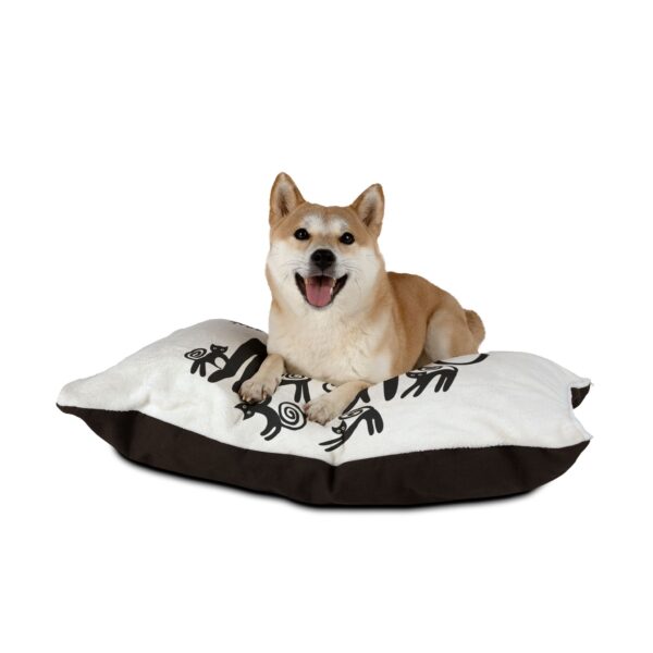 A dog laying on its side on top of a pillow.