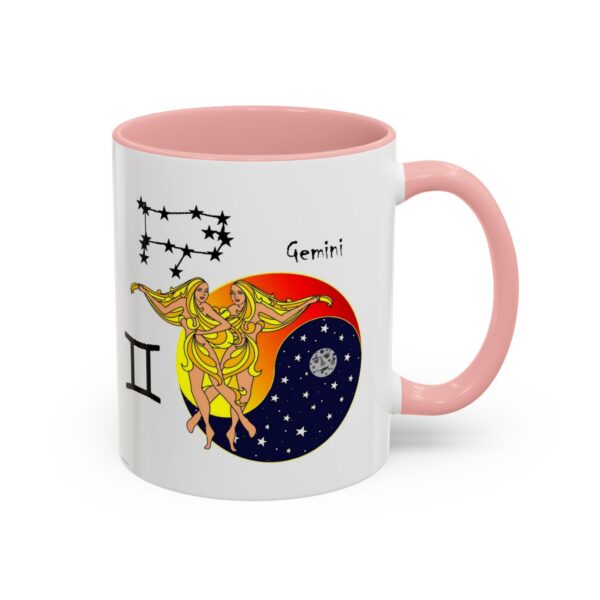 A pink and white mug with an illustration of the zodiac sign gemini.