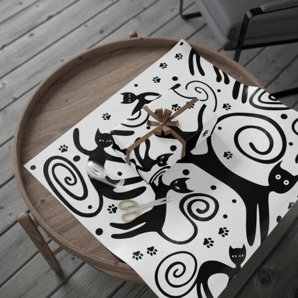 A black and white picture of cats on the table