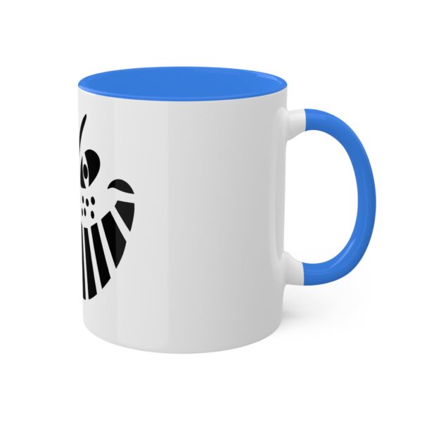 A white and blue coffee mug with the shield of loki on it.