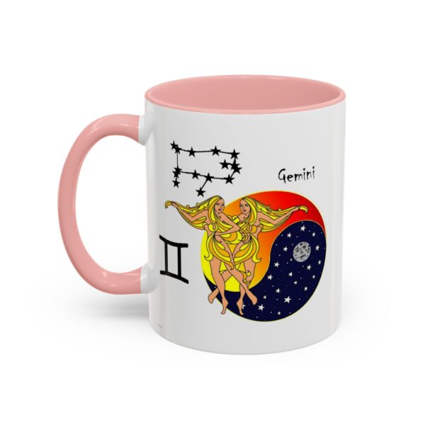 A pink and white mug with an illustration of gemini