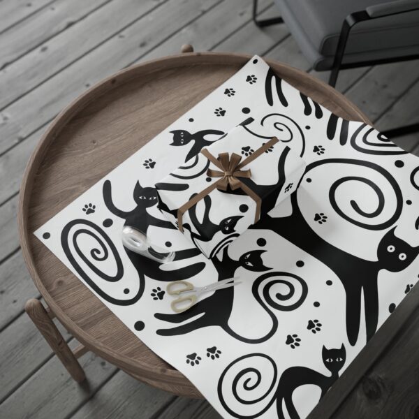 A black and white picture of cats on the table