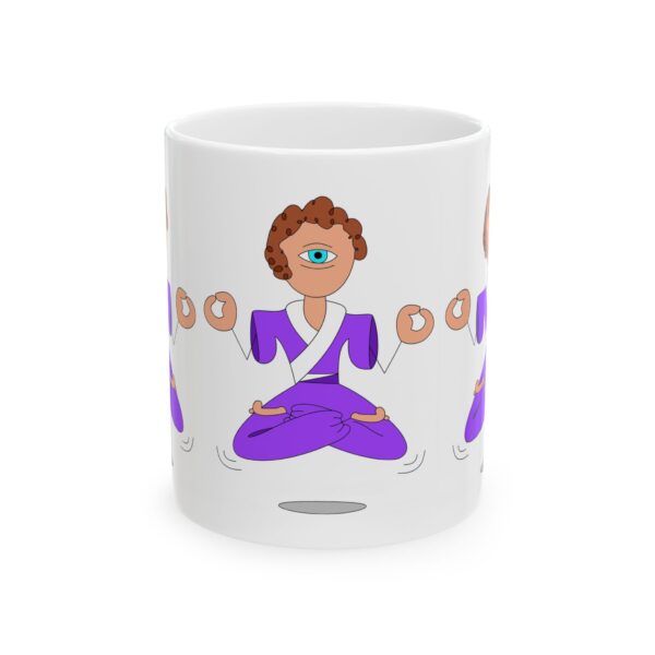 A white mug with a woman in purple and white sitting on the ground.