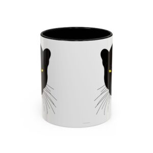 A black and white mug with a cat face on it.