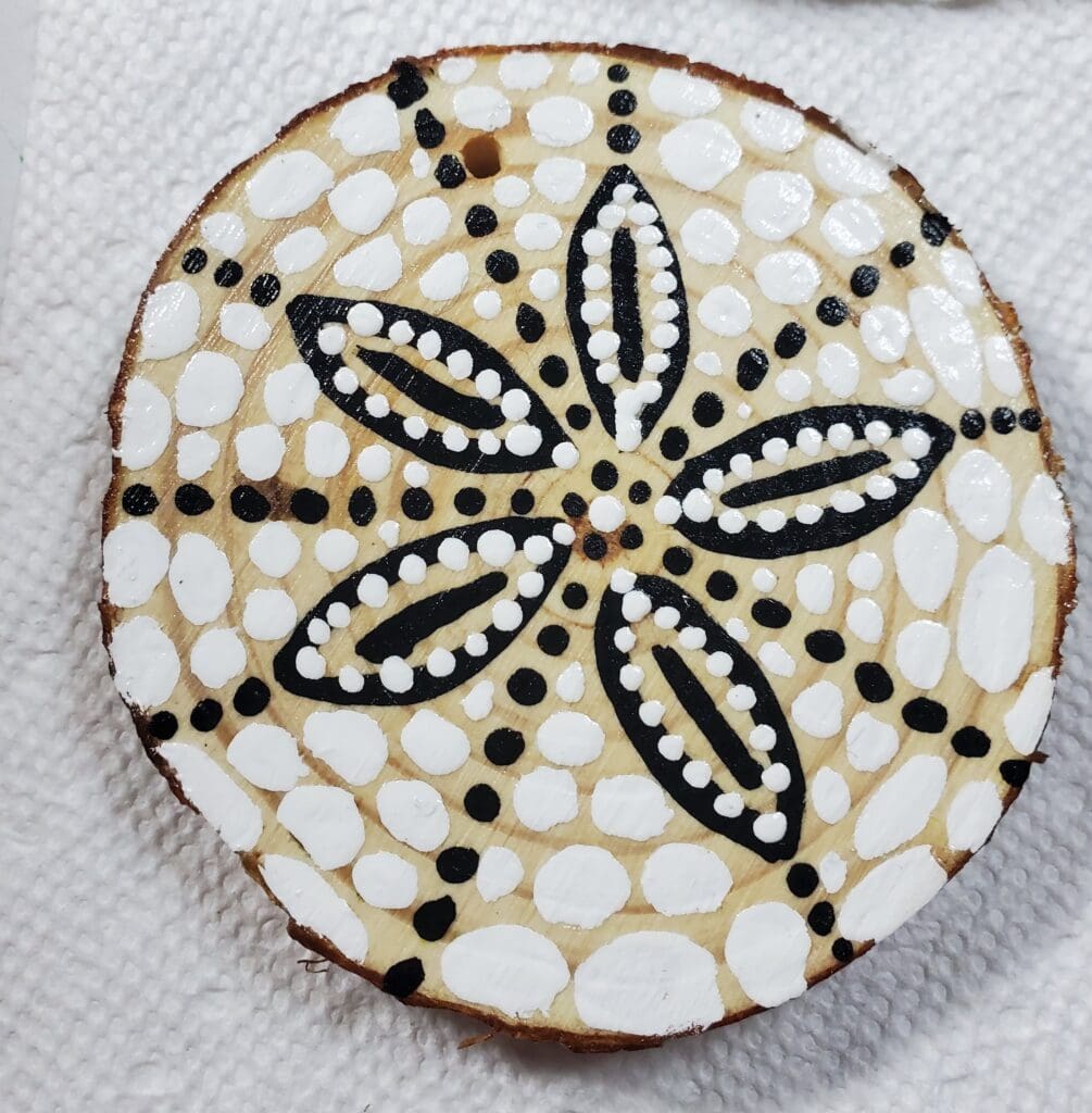 A cookie with black and white designs on it.