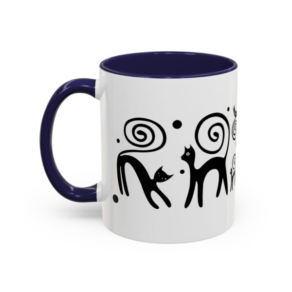 A mug with an image of two cats and swirls.