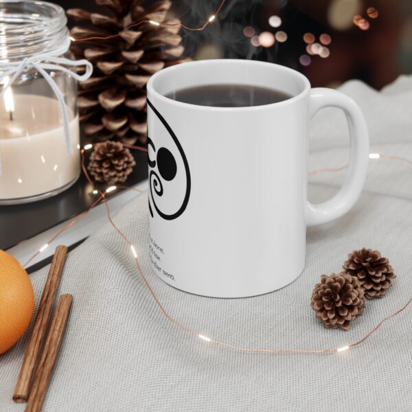 A white coffee mug sitting on top of a table.