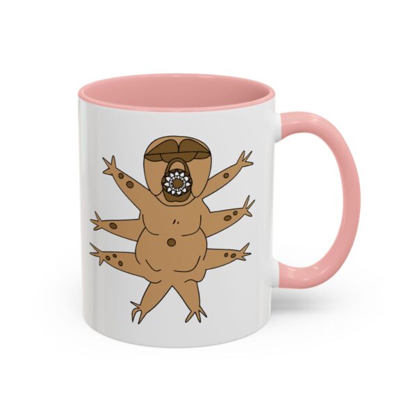 A pink and white mug with an image of a naked man